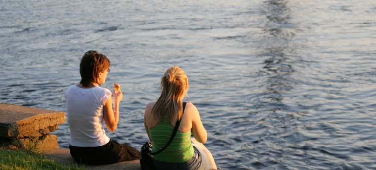 two women with a lake communication