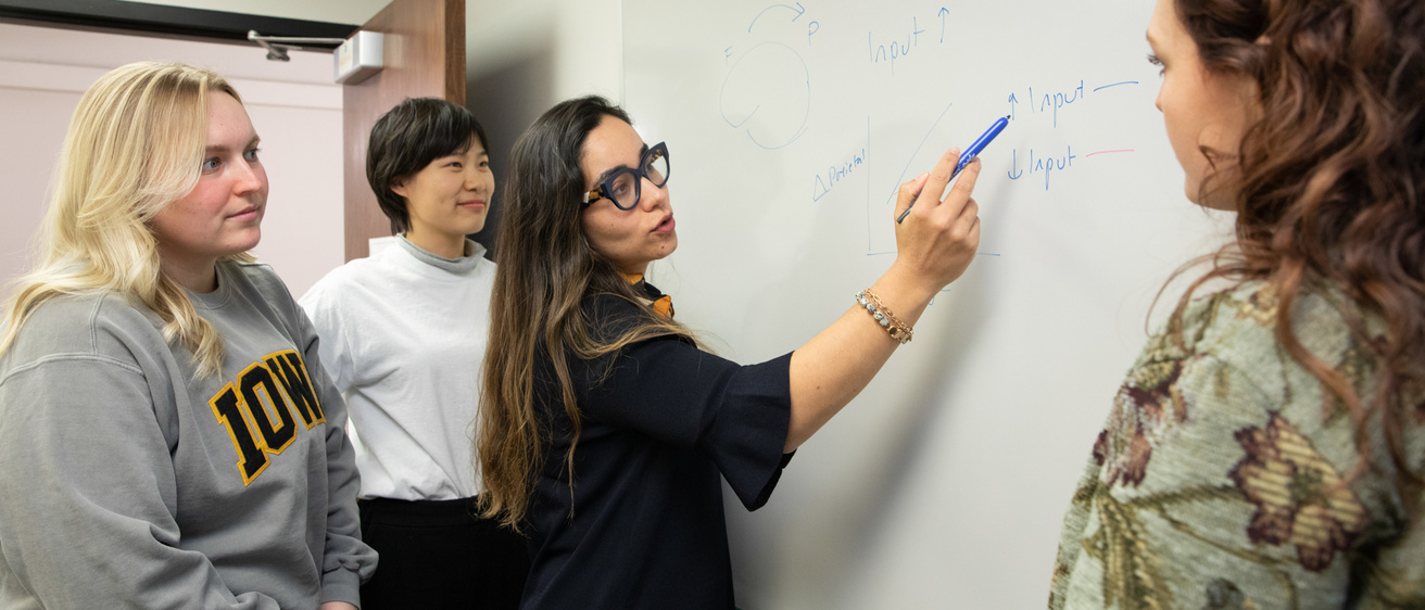 Professor teaching around a group of students
